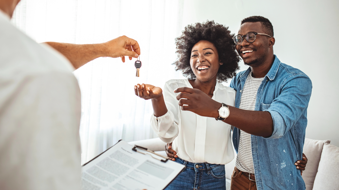 Realtor Giving Keys to Couple
